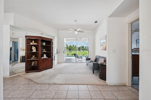 8921 Kilmer Way, Hudson, FL 34667 - foyer entrance with light colored carpet, ceiling fan, and light tile patterned floors