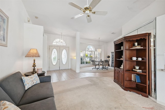 8921 Kilmer Way, Hudson, FL 34667 - living room featuring light tile patterned flooring, ceiling fan, light carpet, and a chandelier