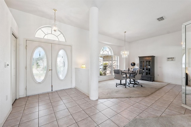 8921 Kilmer Way, Hudson, FL 34667 - entrance foyer featuring a chandelier, light carpet, light tile patterned floors, a towering ceiling, and french doors