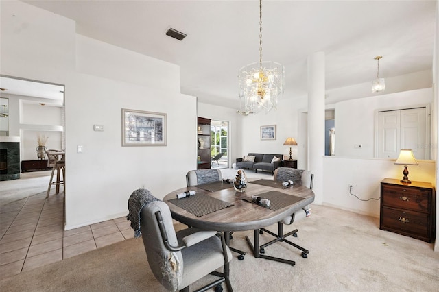 8921 Kilmer Way, Hudson, FL 34667 - dining area with a chandelier, light tile patterned flooring, and light carpet