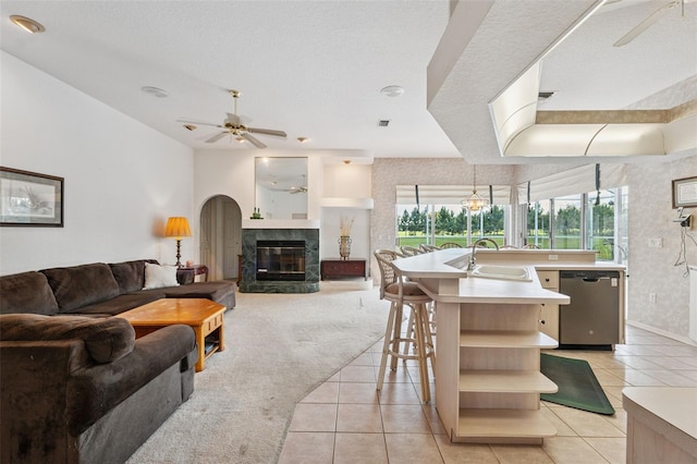 8921 Kilmer Way, Hudson, FL 34667 - kitchen featuring dishwasher, a ceiling fan, open shelves, open floor plan, and light tile patterned floors