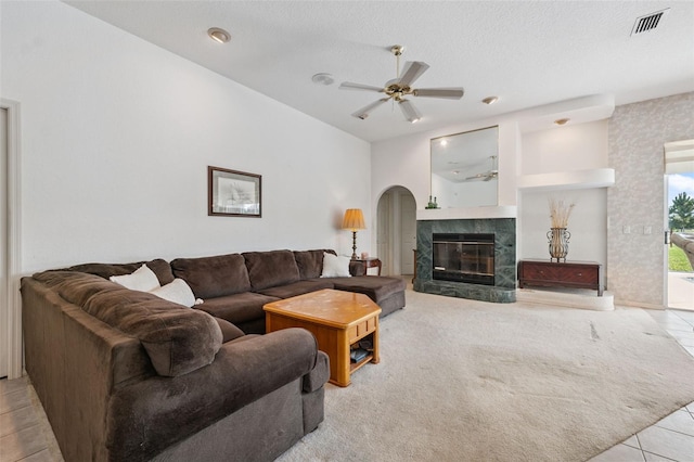 8921 Kilmer Way, Hudson, FL 34667 - tiled living area with a ceiling fan, a fireplace, and a textured ceiling