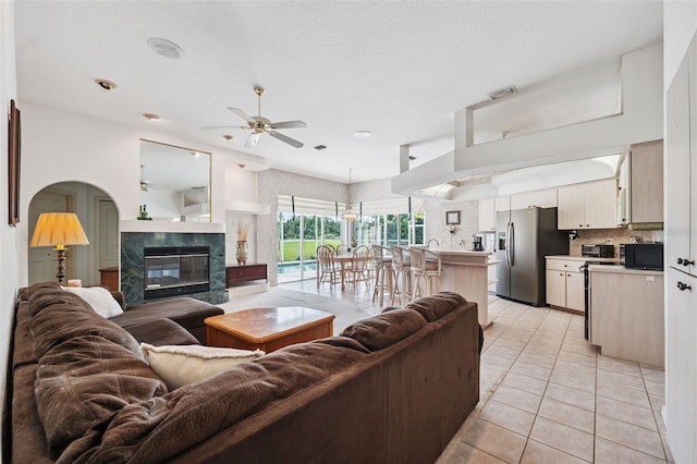 8921 Kilmer Way, Hudson, FL 34667 - living area with a ceiling fan, light tile patterned floors, a high end fireplace, and recessed lighting