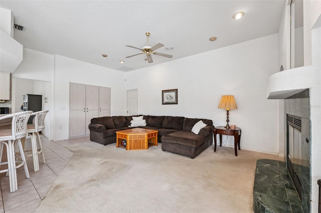 8921 Kilmer Way, Hudson, FL 34667 - living room featuring a fireplace, ceiling fan, light carpet, and light tile patterned floors