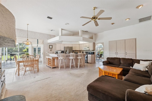 8921 Kilmer Way, Hudson, FL 34667 - living area with a towering ceiling, a ceiling fan, a chandelier, recessed lighting, and light tile patterned floors