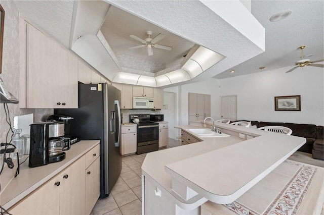 8921 Kilmer Way, Hudson, FL 34667 - kitchen featuring stainless steel appliances, a ceiling fan, light countertops, tasteful backsplash, and light tile patterned flooring