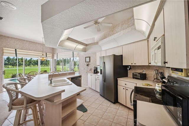 8921 Kilmer Way, Hudson, FL 34667 - kitchen with appliances with stainless steel finishes, ceiling fan, light countertops, a kitchen island with sink, and light tile patterned floors
