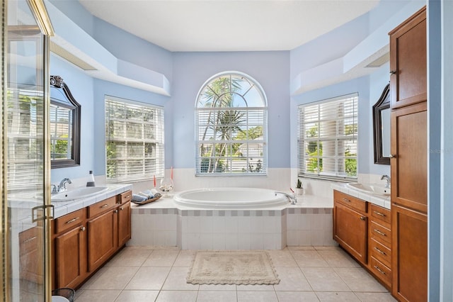 8921 Kilmer Way, Hudson, FL 34667 - full bathroom with two vanities, a garden tub, and tile patterned floors