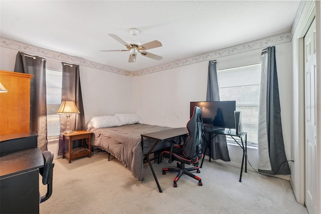 8921 Kilmer Way, Hudson, FL 34667 - carpeted bedroom featuring multiple windows, a closet, ceiling fan, and a desk