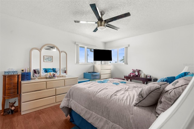 13825 San Juan Ave, Hudson, FL 34667 - bedroom with wood finished floors, a textured ceiling, and a ceiling fan