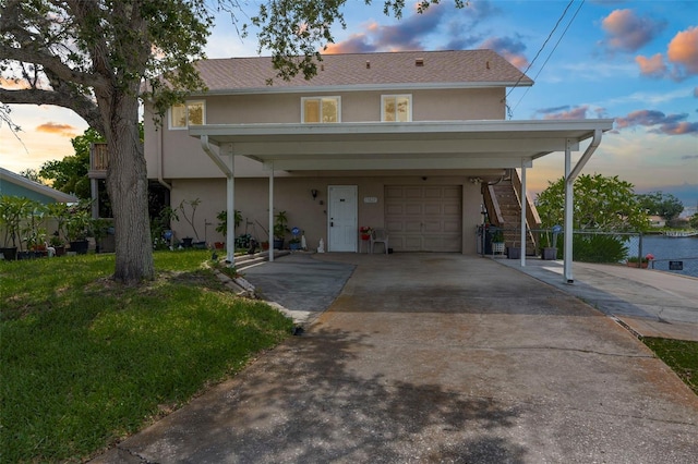 13825 San Juan Ave, Hudson, FL 34667 - view of front of home with an attached garage, stucco siding, stairway, driveway, and a lawn