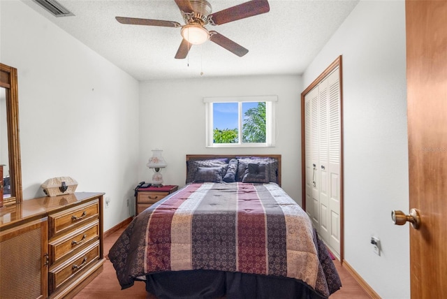 13825 San Juan Ave, Hudson, FL 34667 - bedroom with wood finished floors, a closet, ceiling fan, and a textured ceiling