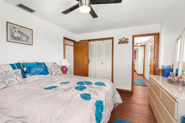 13825 San Juan Ave, Hudson, FL 34667 - bedroom featuring wood finished floors, a closet, ceiling fan, and a textured ceiling