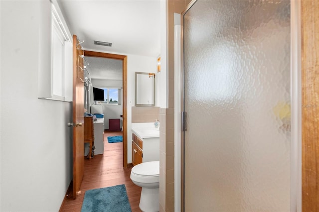 13825 San Juan Ave, Hudson, FL 34667 - ensuite bathroom with vanity, a shower stall, and wood finished floors