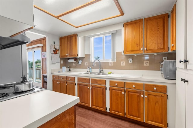 13825 San Juan Ave, Hudson, FL 34667 - kitchen with brown cabinetry and healthy amount of natural light