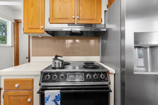 13825 San Juan Ave, Hudson, FL 34667 - kitchen with stainless steel refrigerator with ice dispenser, black range with electric stovetop, range hood, and light countertops