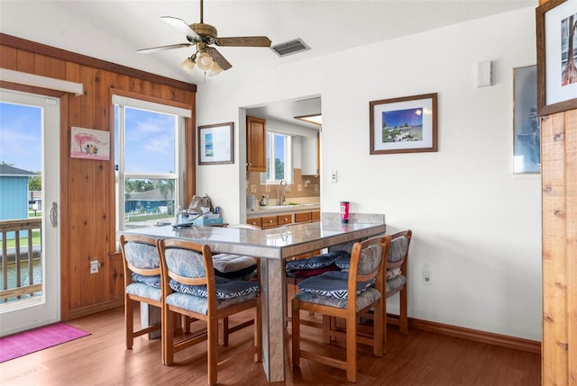 13825 San Juan Ave, Hudson, FL 34667 - dining room with light wood-style flooring, lofted ceiling, and a ceiling fan