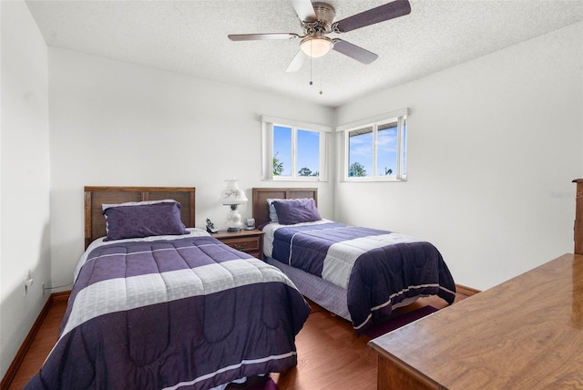 13825 San Juan Ave, Hudson, FL 34667 - bedroom featuring dark wood finished floors, a textured ceiling, and a ceiling fan