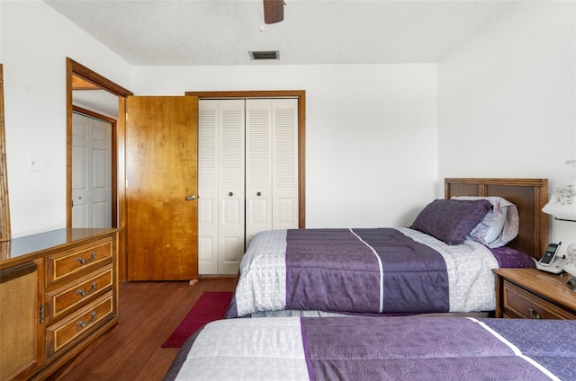 13825 San Juan Ave, Hudson, FL 34667 - bedroom featuring dark wood-style flooring, a closet, and a ceiling fan