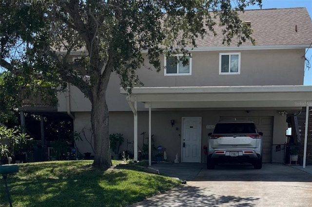 13825 San Juan Ave, Hudson, FL 34667 - view of front of property with stucco siding, concrete driveway, a garage, and a front yard