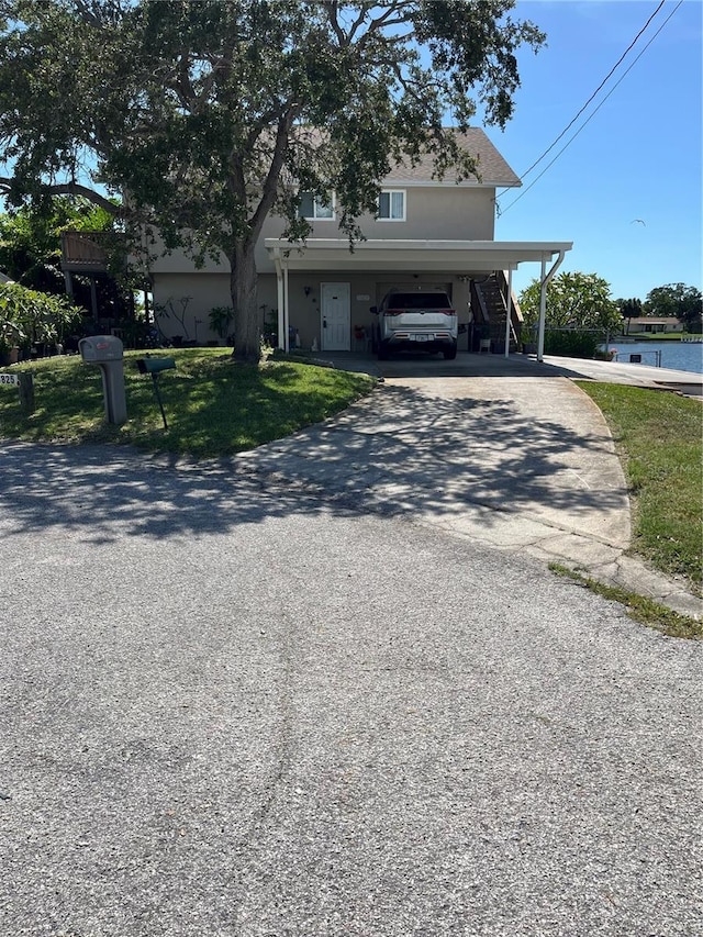 13825 San Juan Ave, Hudson, FL 34667 - view of front of home with gravel driveway and a front yard