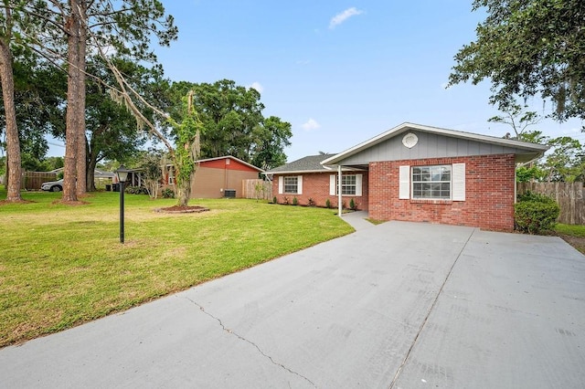 4905 Toni Ave, Lakeland, FL 33812 - single story home with brick siding and concrete driveway