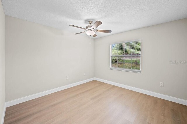 4905 Toni Ave, Lakeland, FL 33812 - empty room with light wood finished floors, a textured ceiling, and ceiling fan