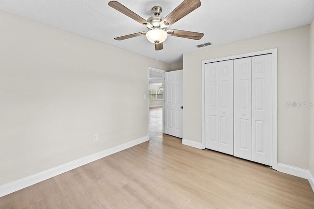 4905 Toni Ave, Lakeland, FL 33812 - unfurnished bedroom with light wood finished floors, a closet, and a ceiling fan