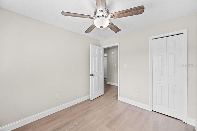 4905 Toni Ave, Lakeland, FL 33812 - unfurnished bedroom featuring light wood finished floors, a closet, and ceiling fan