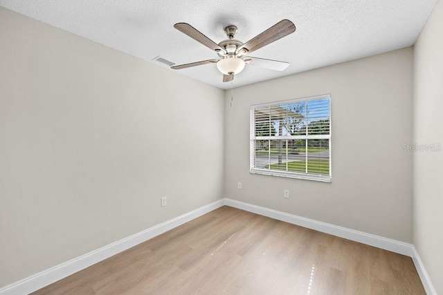 4905 Toni Ave, Lakeland, FL 33812 - unfurnished room featuring light wood-style floors, ceiling fan, and a textured ceiling
