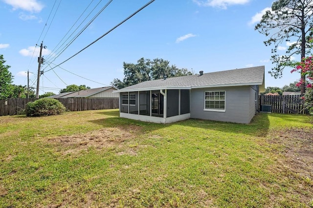 4905 Toni Ave, Lakeland, FL 33812 - rear view of house with a sunroom and a fenced backyard