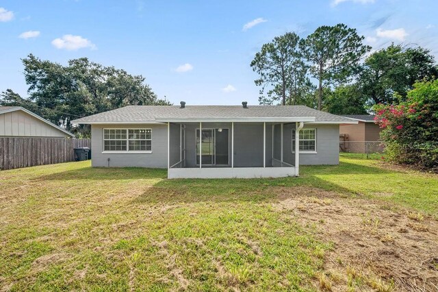 4905 Toni Ave, Lakeland, FL 33812 - back of property featuring a sunroom and a fenced backyard