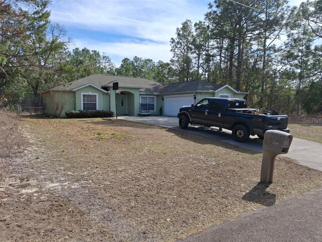 7689 N Galt Pt, Dunnellon, FL 34434 - ranch-style house with concrete driveway and a garage