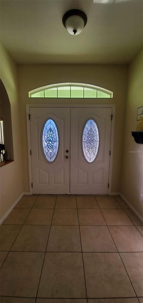 7689 N Galt Pt, Dunnellon, FL 34434 - entryway featuring light tile patterned floors and plenty of natural light