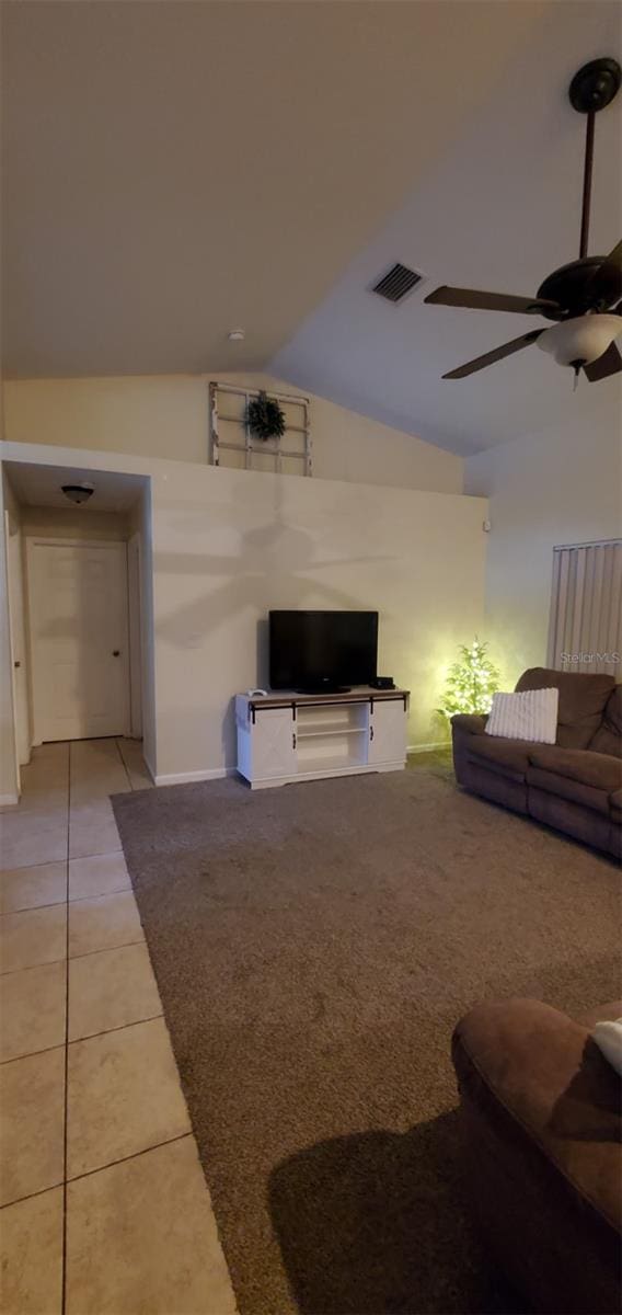 7689 N Galt Pt, Dunnellon, FL 34434 - living area with lofted ceiling, a ceiling fan, and light tile patterned floors
