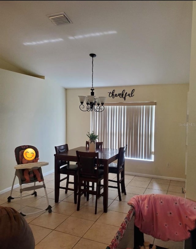 7689 N Galt Pt, Dunnellon, FL 34434 - dining area featuring a chandelier and light tile patterned flooring