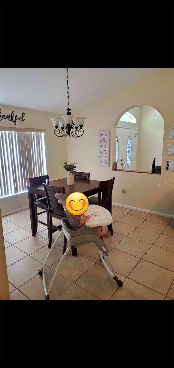 7689 N Galt Pt, Dunnellon, FL 34434 - dining area with light tile patterned floors and arched walkways