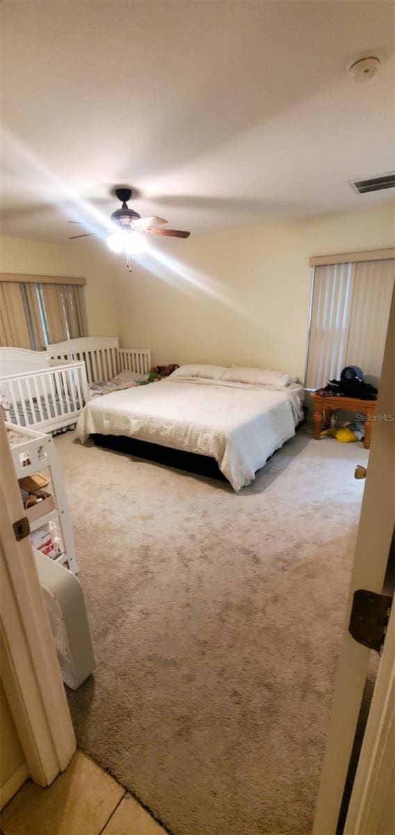 7689 N Galt Pt, Dunnellon, FL 34434 - bedroom featuring light colored carpet and a ceiling fan