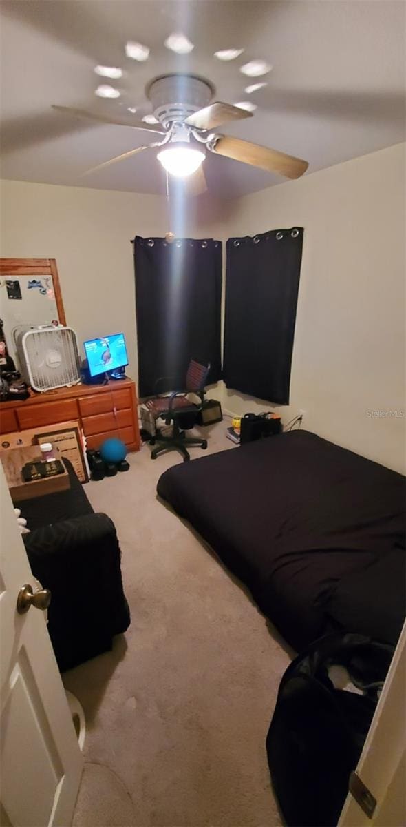 7689 N Galt Pt, Dunnellon, FL 34434 - bedroom featuring carpet flooring and ceiling fan