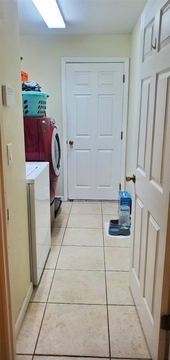7689 N Galt Pt, Dunnellon, FL 34434 - laundry room featuring washer and clothes dryer and light tile patterned flooring