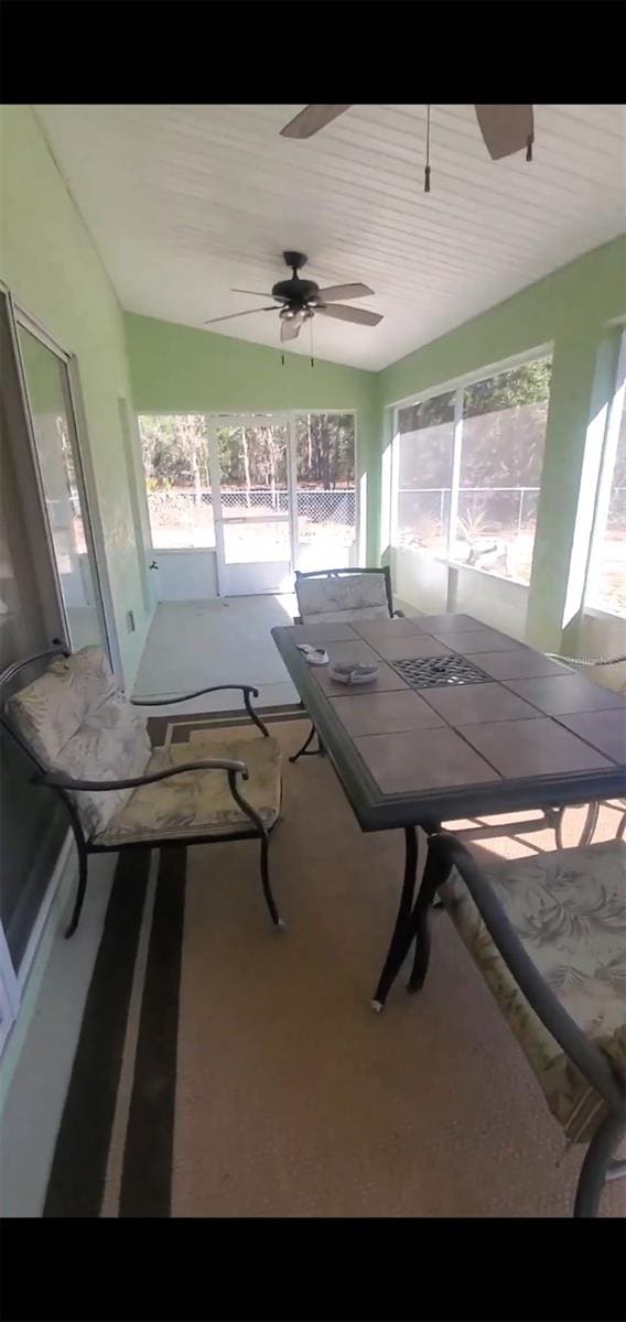 7689 N Galt Pt, Dunnellon, FL 34434 - sunroom / solarium with a ceiling fan, healthy amount of natural light, and outdoor dining space