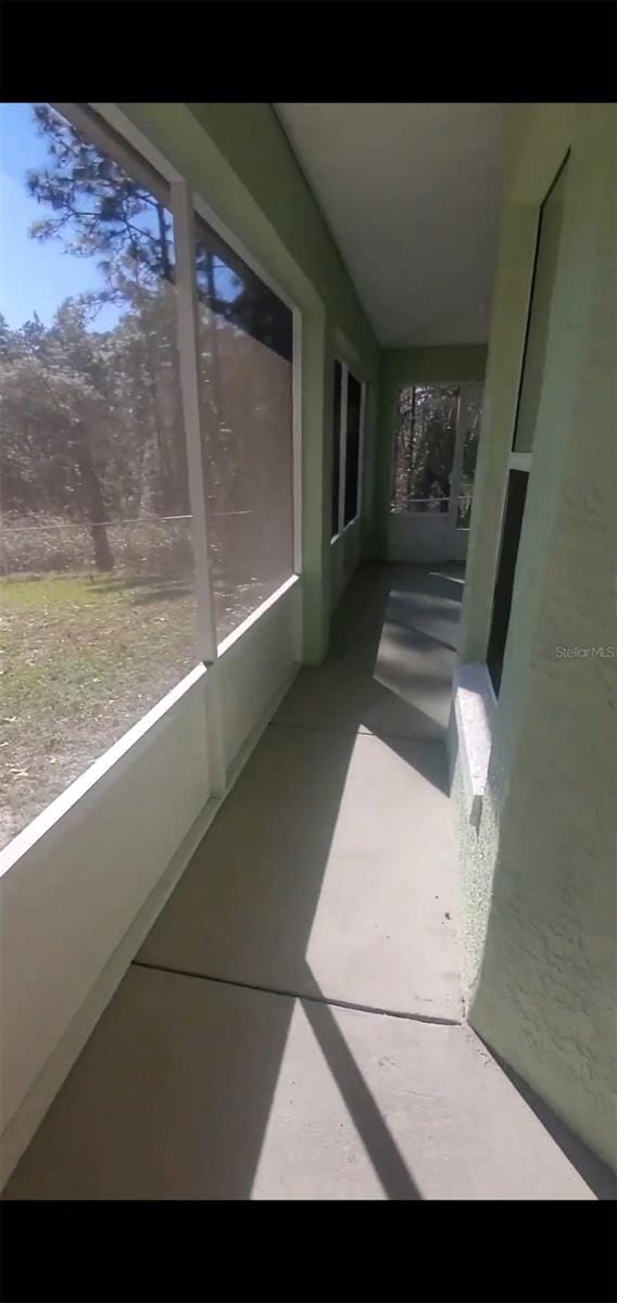 7689 N Galt Pt, Dunnellon, FL 34434 - unfurnished sunroom with vaulted ceiling