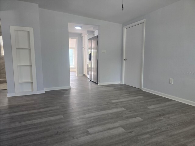 6730 Sandra Dr, Port Richey, FL 34668 - unfurnished room featuring built in shelves and dark wood-style floors