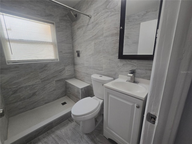 6730 Sandra Dr, Port Richey, FL 34668 - bathroom with a tile shower, vanity, tile walls, and marble look tiles