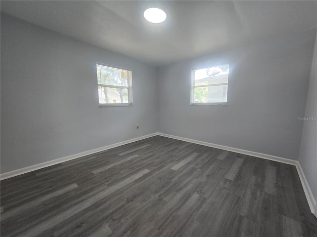 6730 Sandra Dr, Port Richey, FL 34668 - unfurnished room with dark wood-type flooring and baseboards