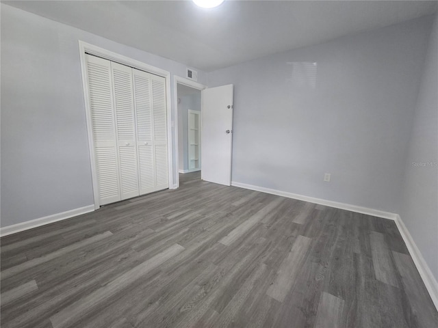 6730 Sandra Dr, Port Richey, FL 34668 - unfurnished bedroom featuring a closet and dark wood-style flooring