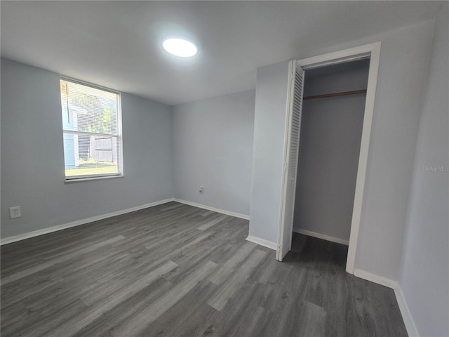 6730 Sandra Dr, Port Richey, FL 34668 - unfurnished bedroom with dark wood-type flooring and a closet