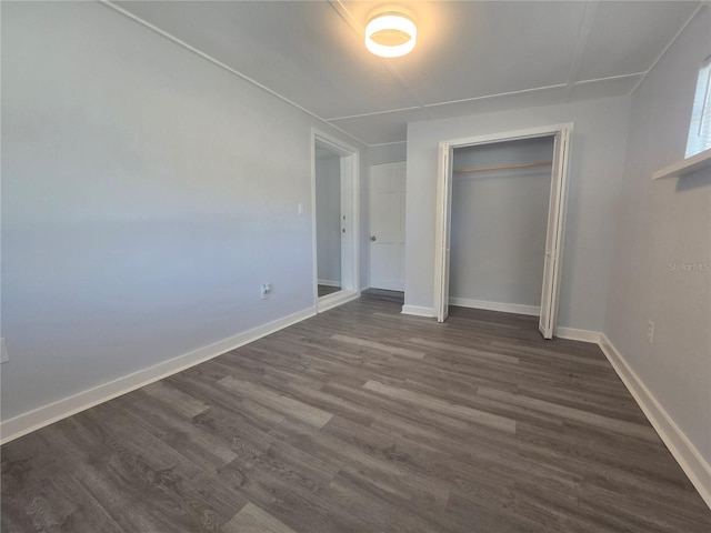6730 Sandra Dr, Port Richey, FL 34668 - unfurnished bedroom with dark wood-style flooring and a closet
