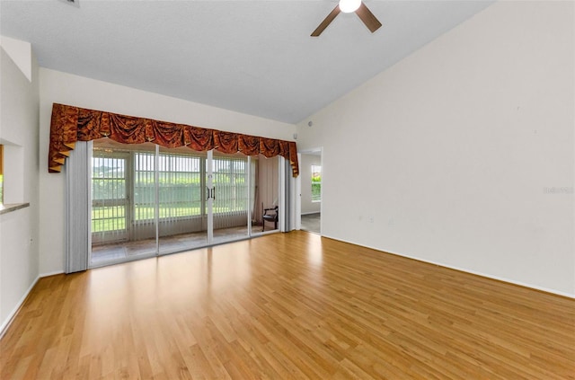9519 Scenic Pine Ct, New Port Richey, FL 34655 - spare room featuring light wood-type flooring, ceiling fan, and vaulted ceiling