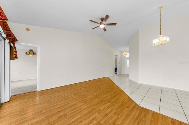 9519 Scenic Pine Ct, New Port Richey, FL 34655 - unfurnished living room featuring a chandelier, a ceiling fan, lofted ceiling, and light wood-style floors